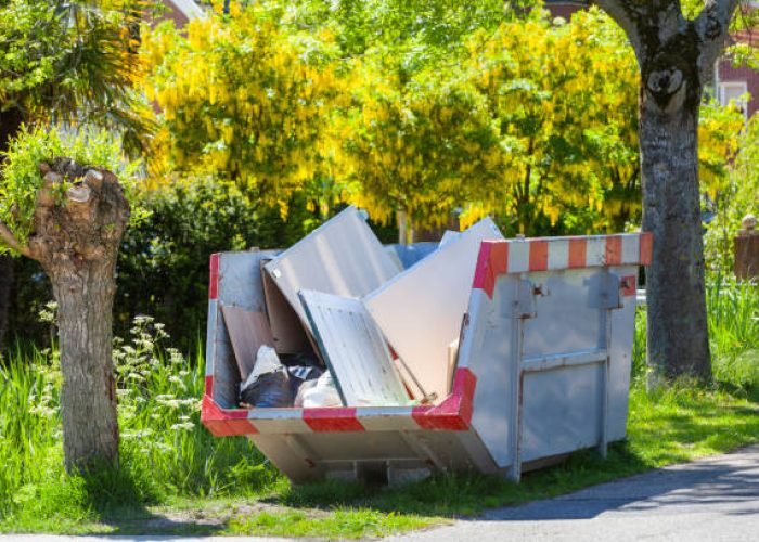skip with renovation waste under trees in rotterdam in the netherlands